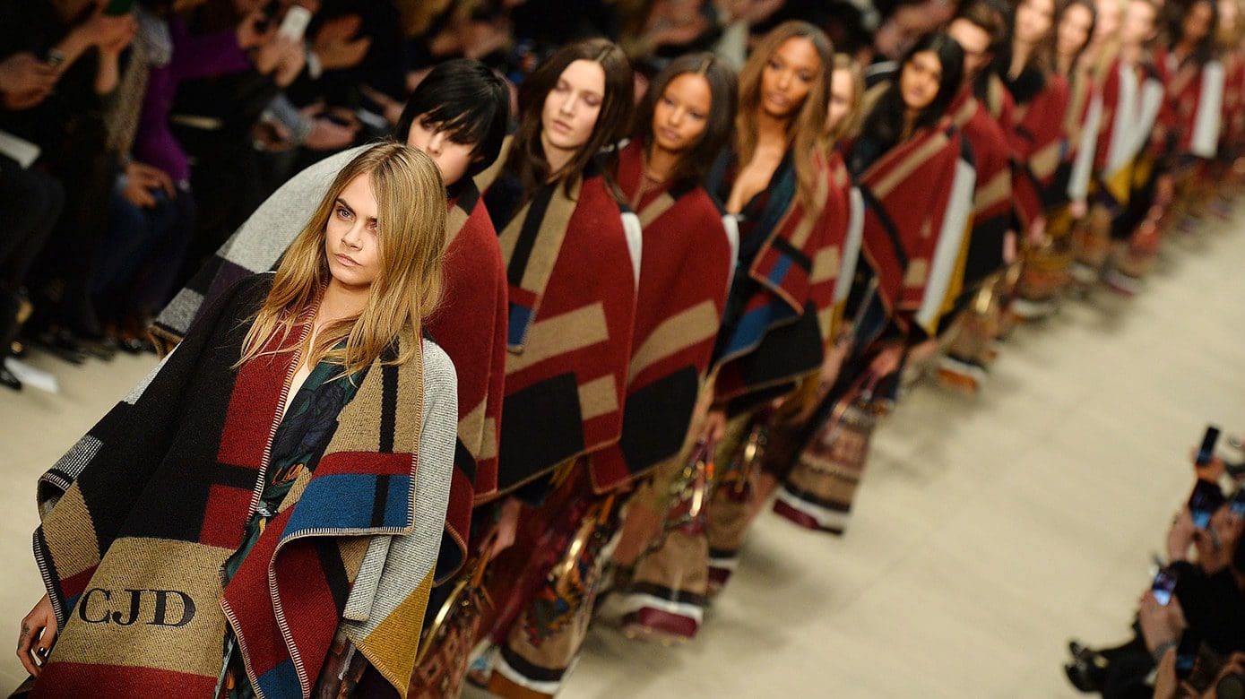 Models, led by Cara Delevingne (L) prese History of the Fashion Week